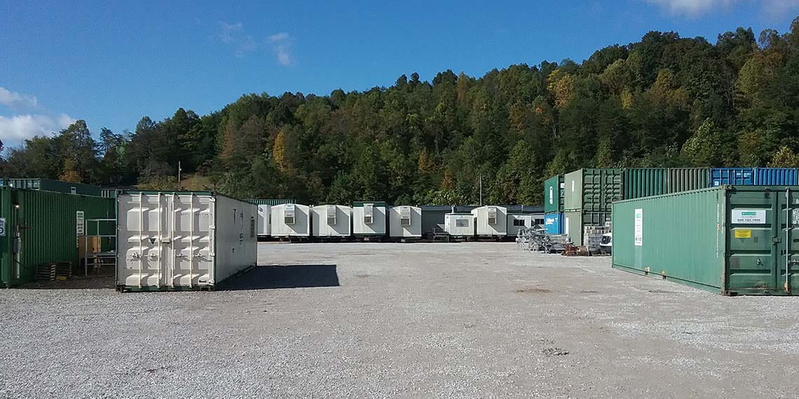 various types of containers stacked next to portable trailers at a lot at WillScot Charleston, WV