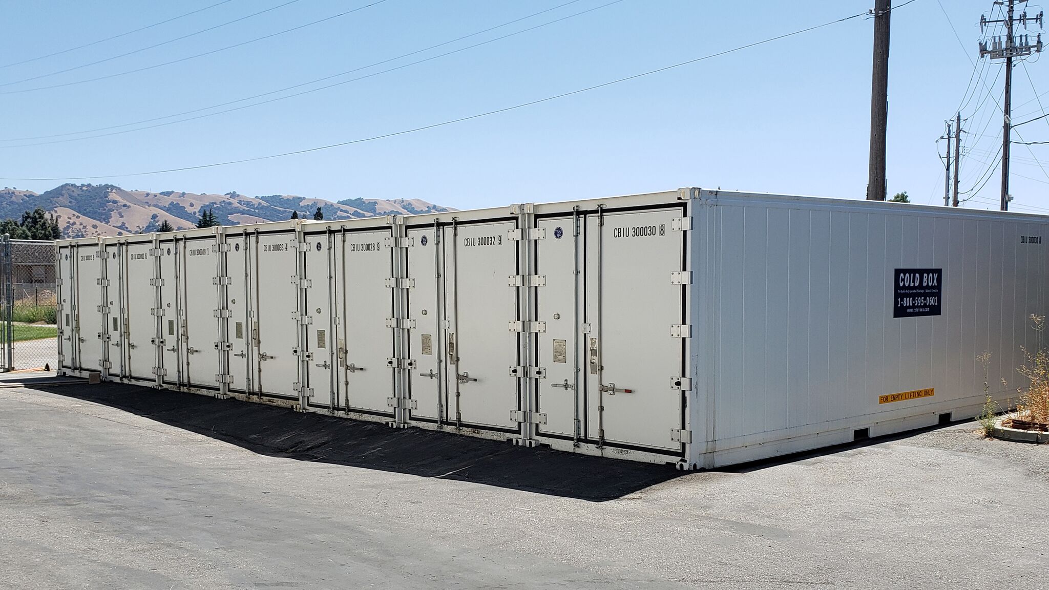 A series of cold storage containers in a lot