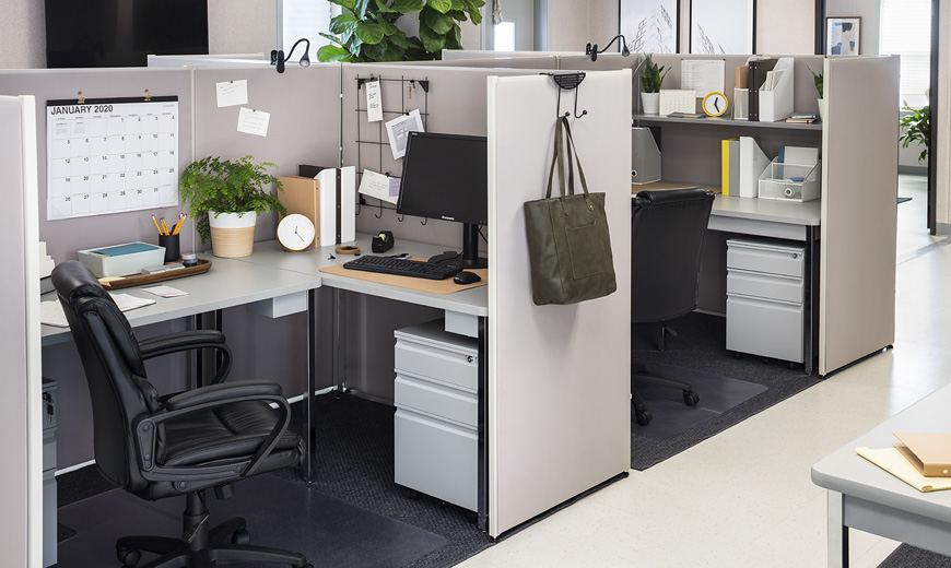Furnished professional level office cubicle containing office supplies and a hanger