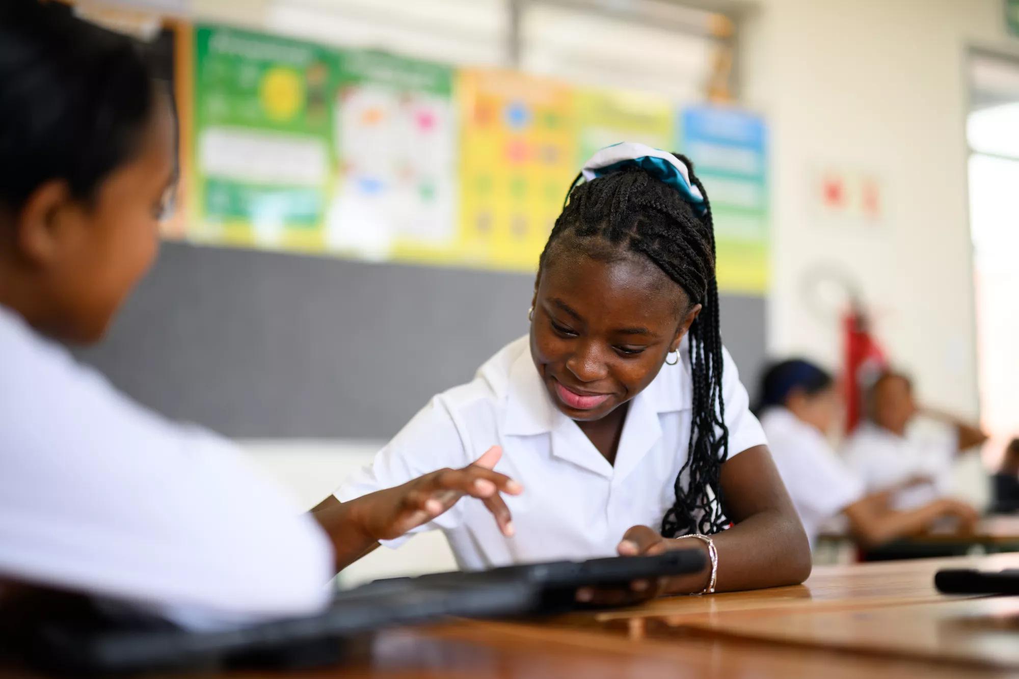Young schoolchildren using digital tablets to learn maths in class